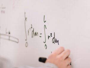 person writing on white paper